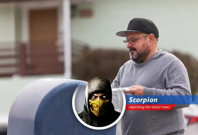 A close-up of a letter being dropped into a USPS mailbox, highlighting the potential postmarking delays.