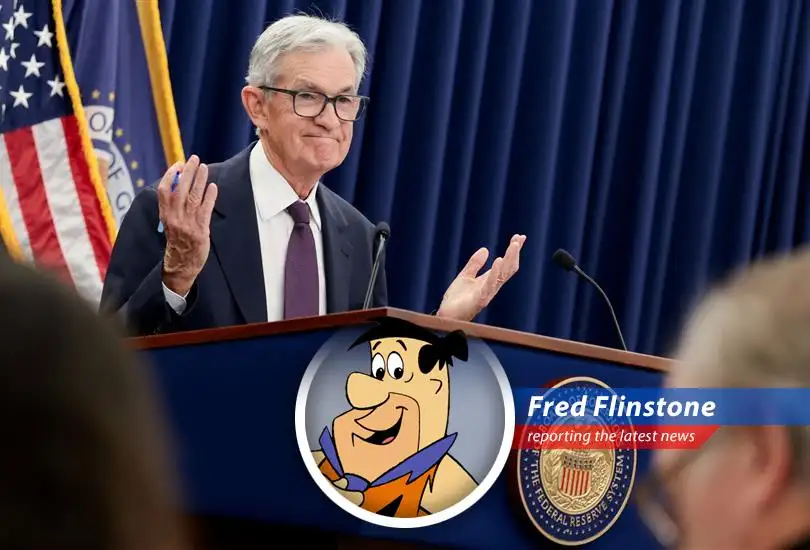 A frustrated Fred Flintstone ponders his financial future amidst rising inflation and stalled interest rate cuts.