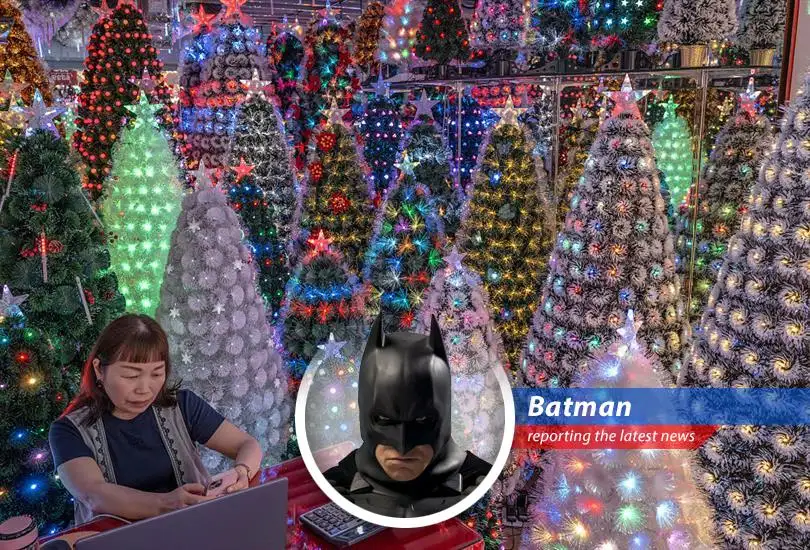 A manufacturer in Yiwu, China, showcases artificial Christmas trees amidst concerns over rising production and shipping costs.