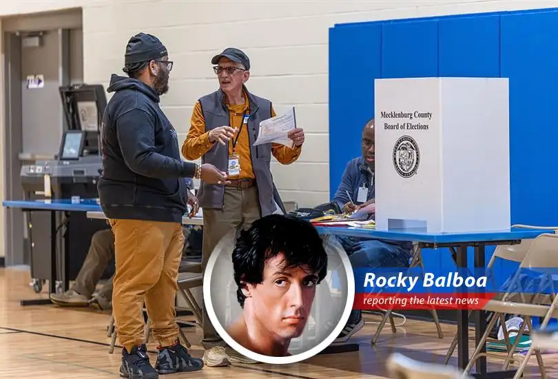 A poll worker assists a voter, highlighting the vital role these individuals play in safeguarding American elections.