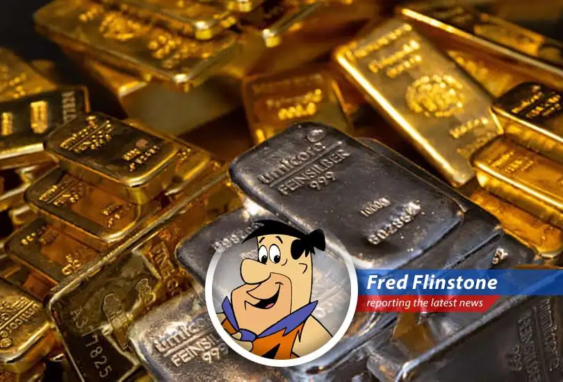 Fred Flinstone pondering the gold market's turmoil, wondering if he should trade his bowling ball for bullion.