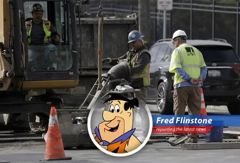 Fred Flinstone ponders the economic downturn, wondering if he'll still be able to afford those bronto burgers.