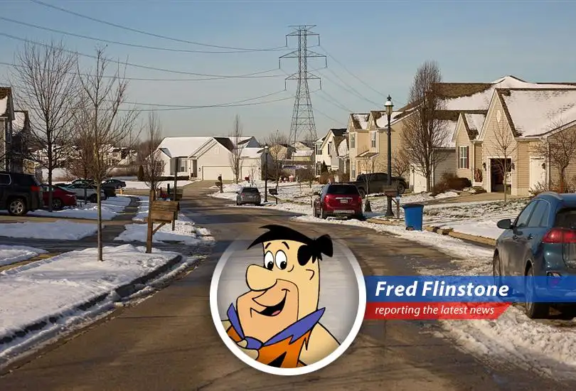 Fred Flinstone staring at an electricity bill, realizing even bedrock budgets can't handle AI's power-hungry appetite.