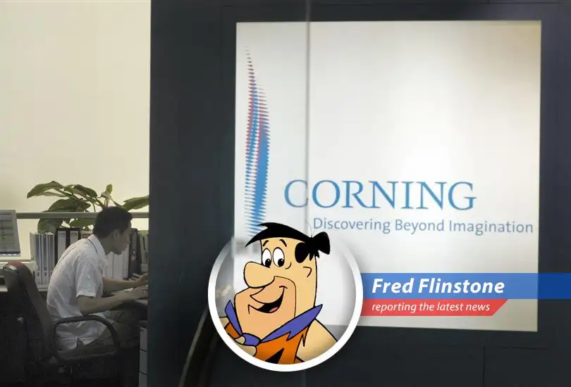 Fred Flintstone ponders the stock market, wondering if he should invest his hard-earned clams in dinosaur-powered technology.