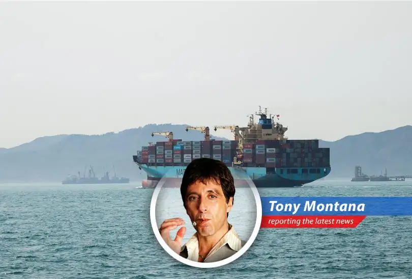 Maersk ship under US Navy escort through the Strait of Hormuz, a tense but vital passage.