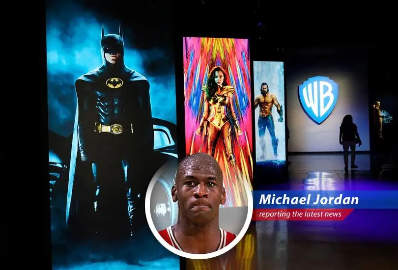 Netflix logo displayed on a screen next to the Warner Bros. logo, symbolizing the merger.