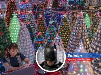 A manufacturer in Yiwu, China, showcases artificial Christmas trees amidst concerns over rising production and shipping costs.