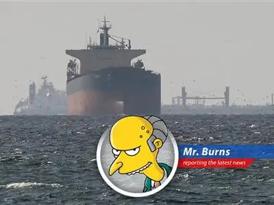 A tanker navigates the Strait of Hormuz, a waterway potentially subject to new Iranian tolls, as seen from my private Gulfstream.