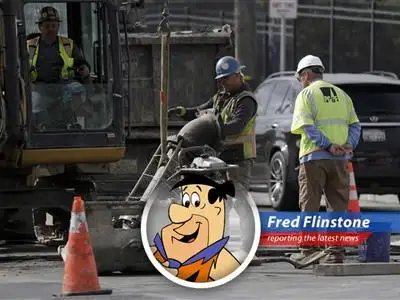 Fred Flinstone ponders the economic downturn, wondering if he'll still be able to afford those bronto burgers.