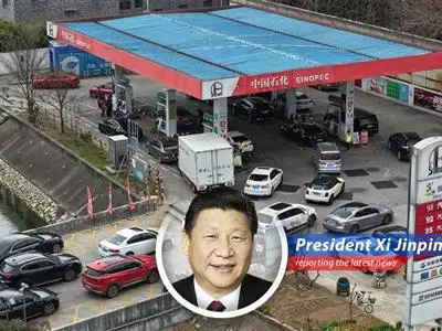 Lines form at Chinese gas stations as residents anticipate a price hike announcement from Sinopec.