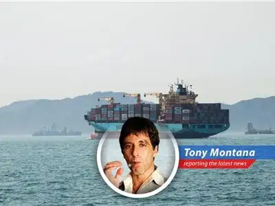 Maersk ship under US Navy escort through the Strait of Hormuz, a tense but vital passage.