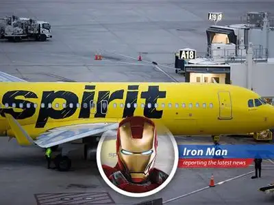 Spirit Airlines aircraft at an airport gate symbolizing fleet adjustments amid financial restructuring.