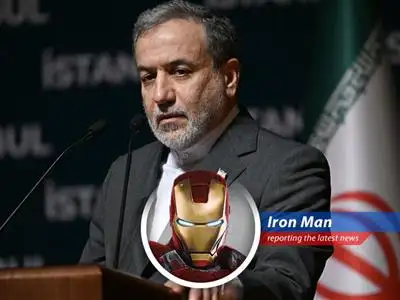 Tony Stark, aka Iron Man, contemplates global peace strategies from his workshop.
